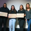 Students on stage with prize checks