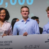 Young white man poses for a picture with a giant prize check