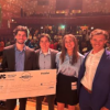 Winners hold up their large prize checks