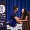 Two actors in their costumes shake hands in character as they perform The Tempest for the Shakespeare and Violence Prevention in Schools program