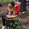 High school student traces tree rings onto plexiglass