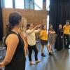 Amanda Giguere directs a group of young people in a performance