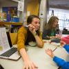 a woman instructs a young boy how to read a chart