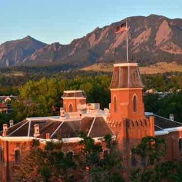 Old Main in spring Flatirons in background