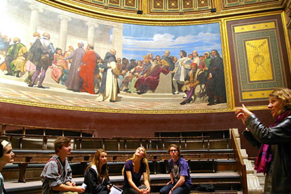 Students taking a class in a French museum looking at art