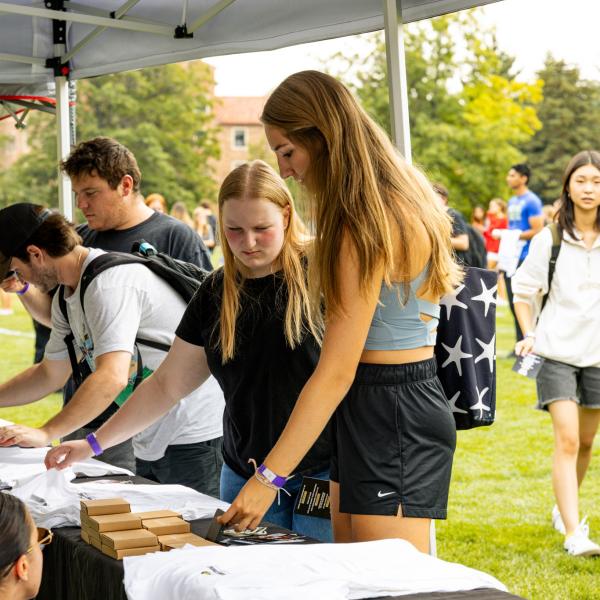 students picking out homecoming t-shirts