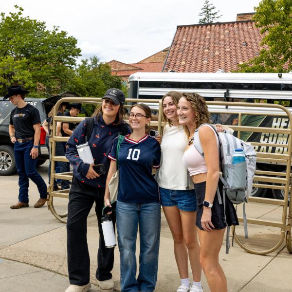 students taking pics at homecoming event