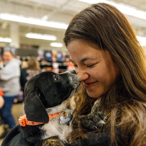 student with puppy