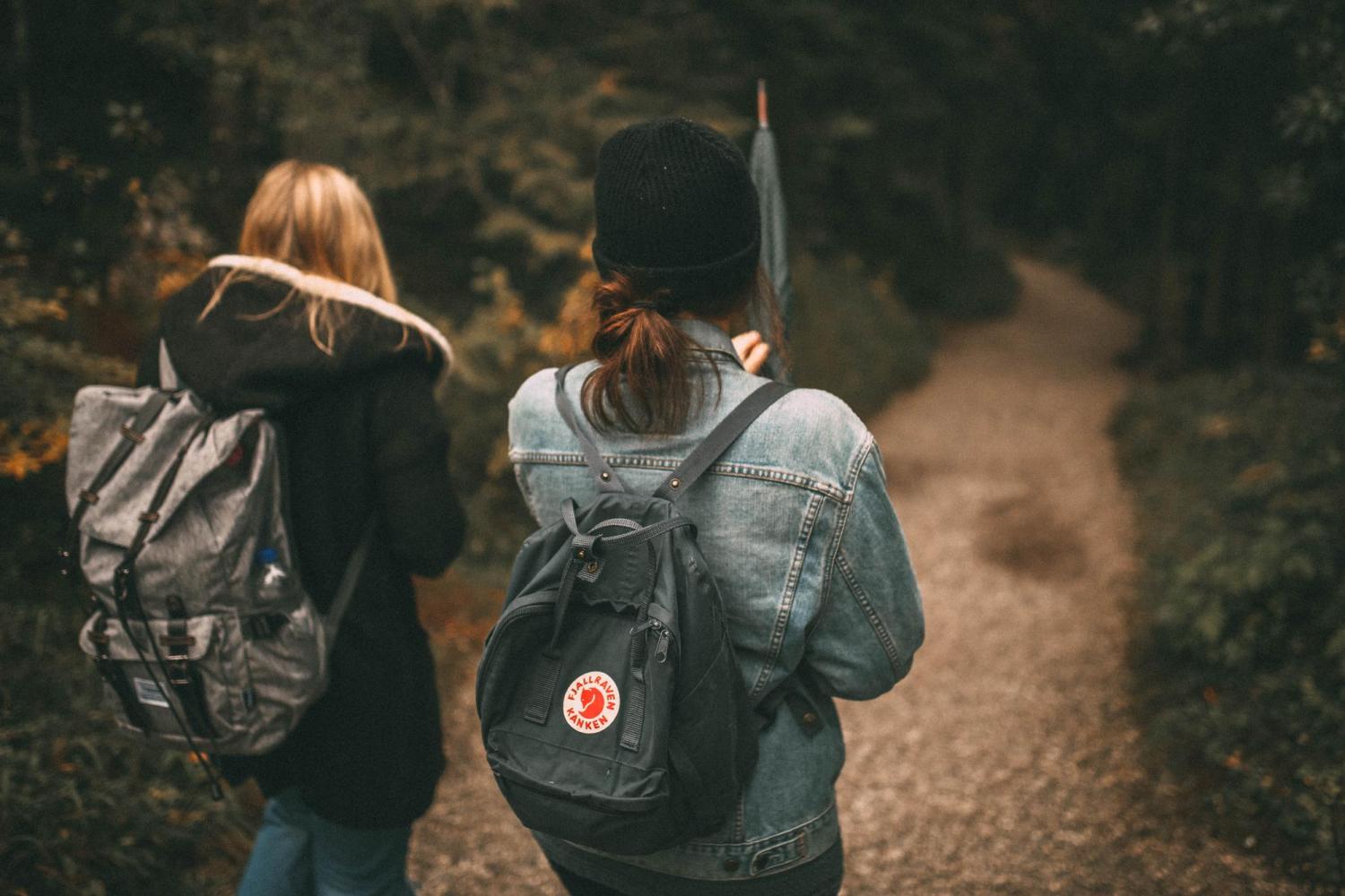 female friends walking in the woods