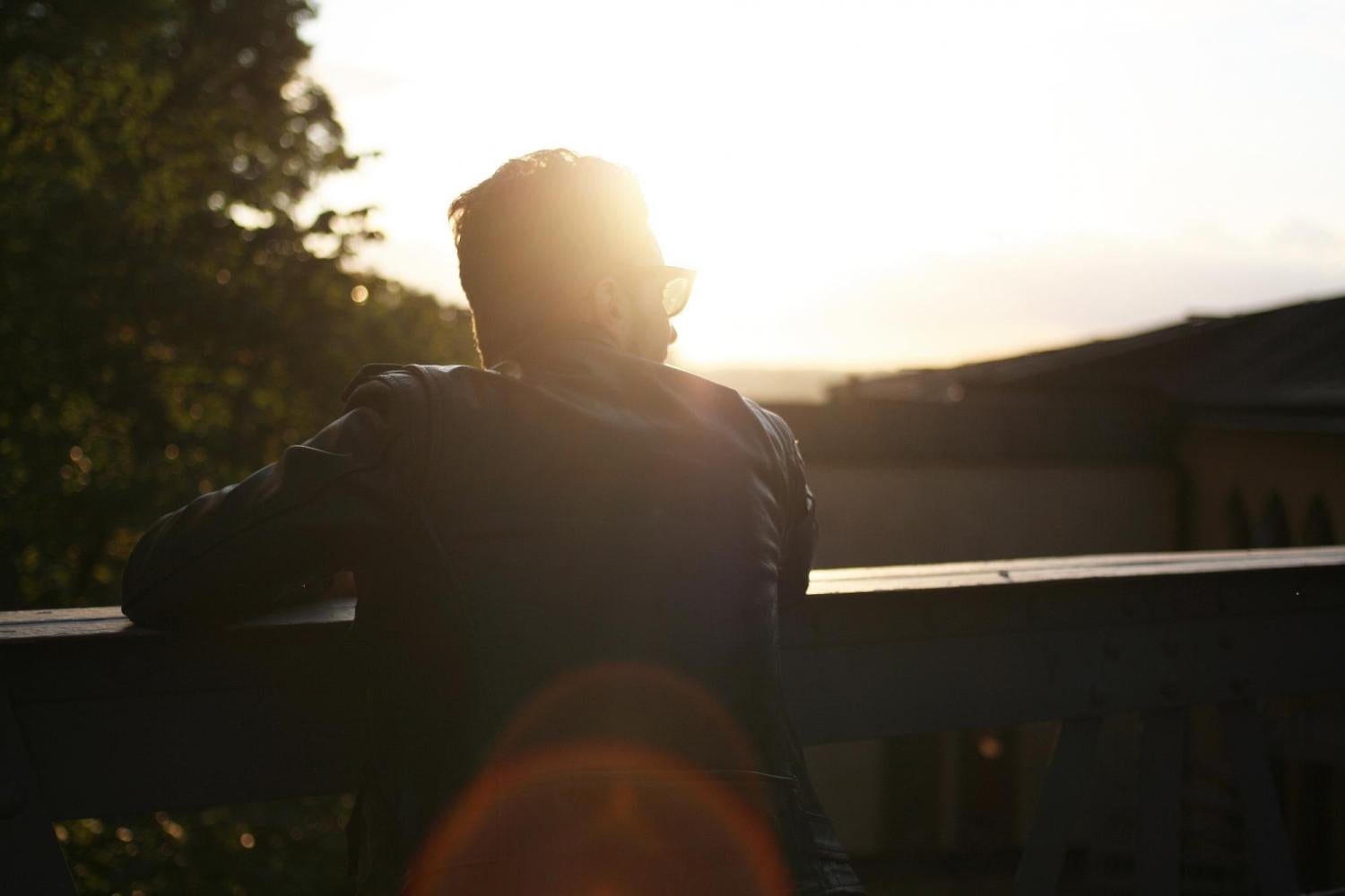 A man stands on a balcony.