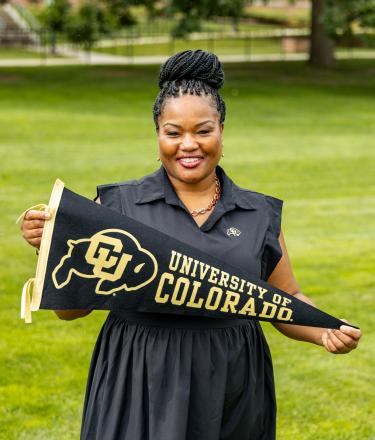 Dr. Mull holding a CU flag