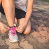 female tying a running shoe