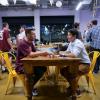 two students have a conversation at a table