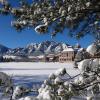 View of the CU Boulder engineering field, Koelbel building, C4C and Flatirons after snowfall.