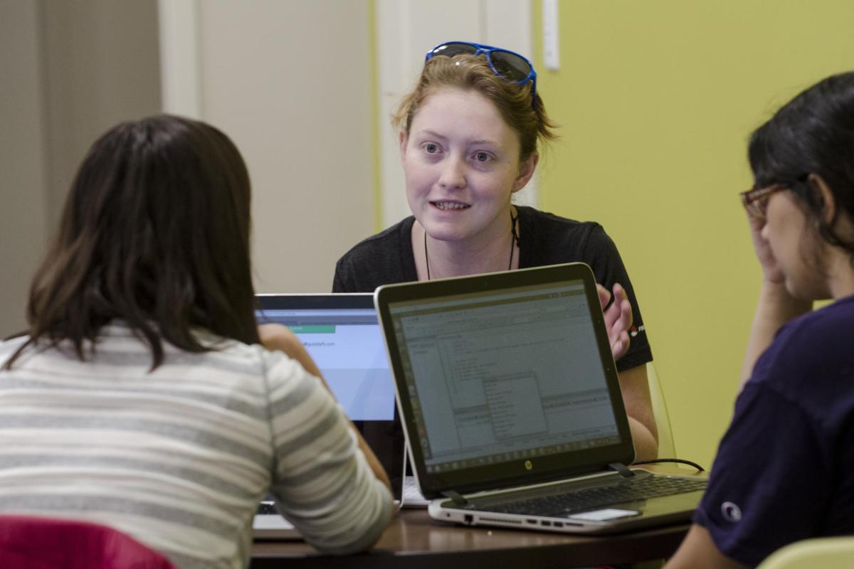 Students meeting with a tutor.