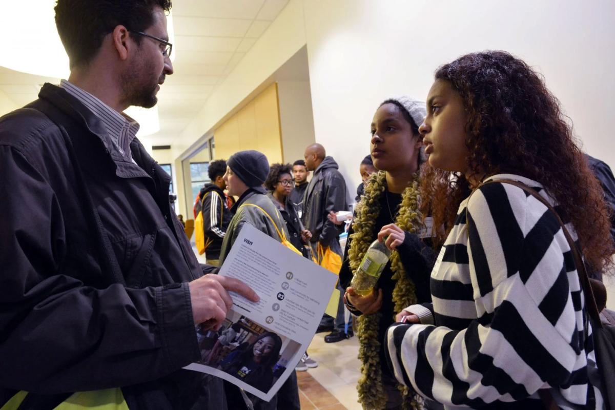 Staff talking to students
