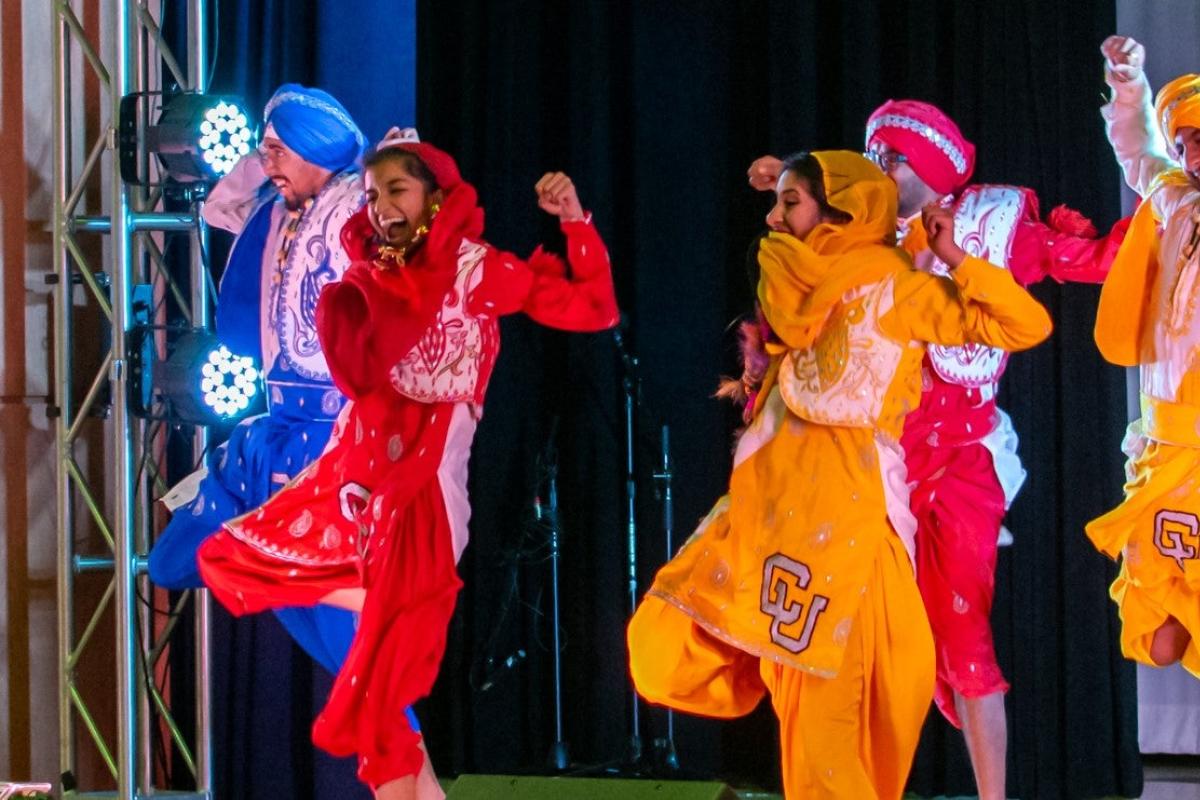 Students in costume dancing on international festival day