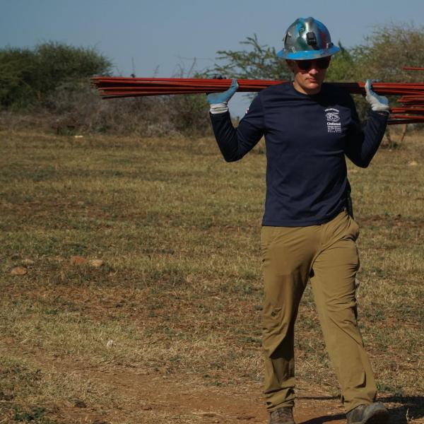Project Manager carries heavy steel rods