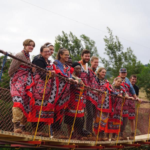 Members standing on Bridge in local dress