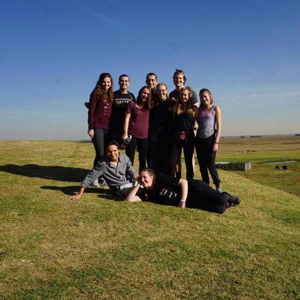 Members in front of open field