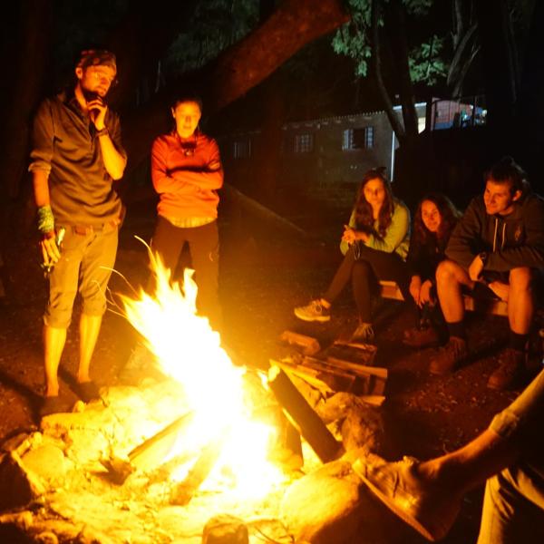 Members aroound a camp fire