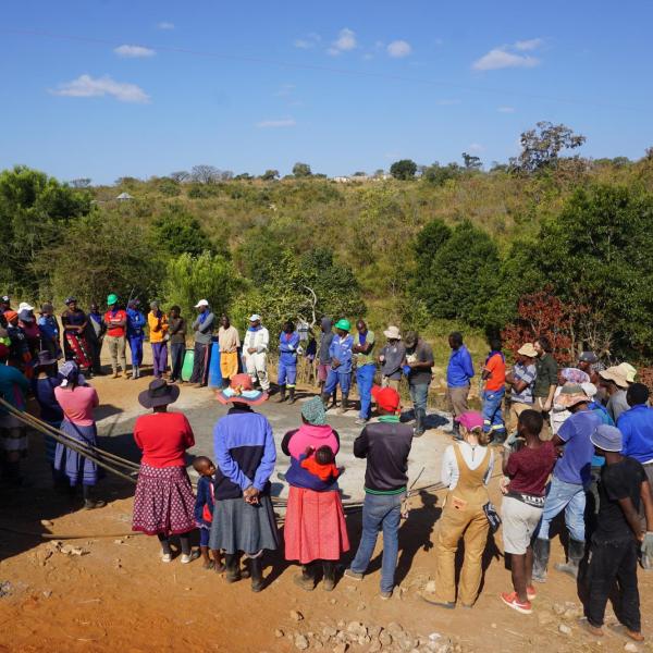 Entire community standing near tower
