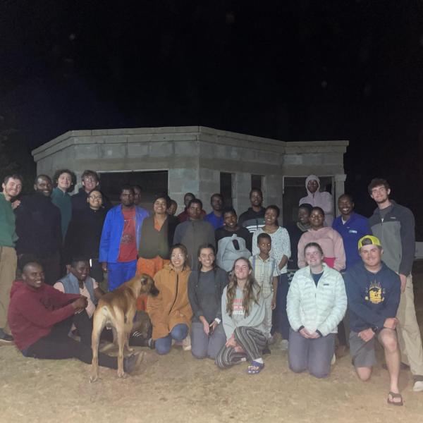 Photo of community members and travel team at night