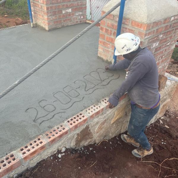 Site foreman writing the date in the ramp concrete cap