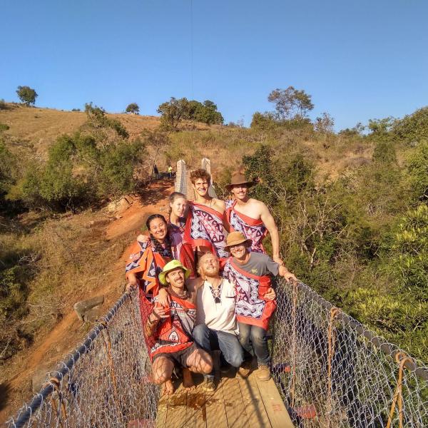 Members standing on completed bridge
