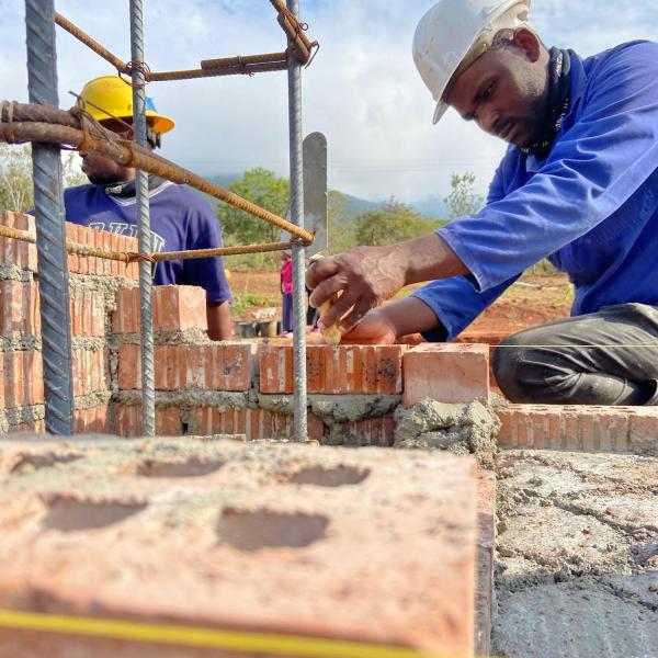 Masons laying brick for tower