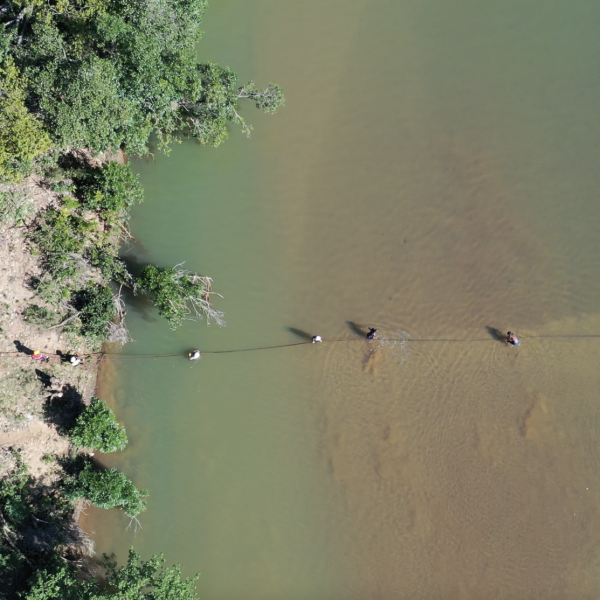 Birds eye view of cable being dragged across river