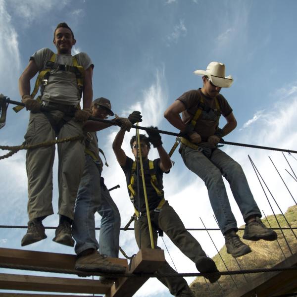 Hanging from unfinished bridge