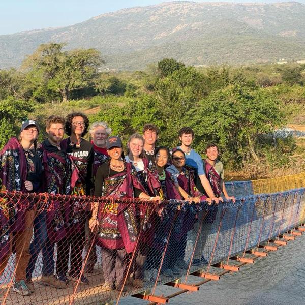 Travel team members on completed bridge