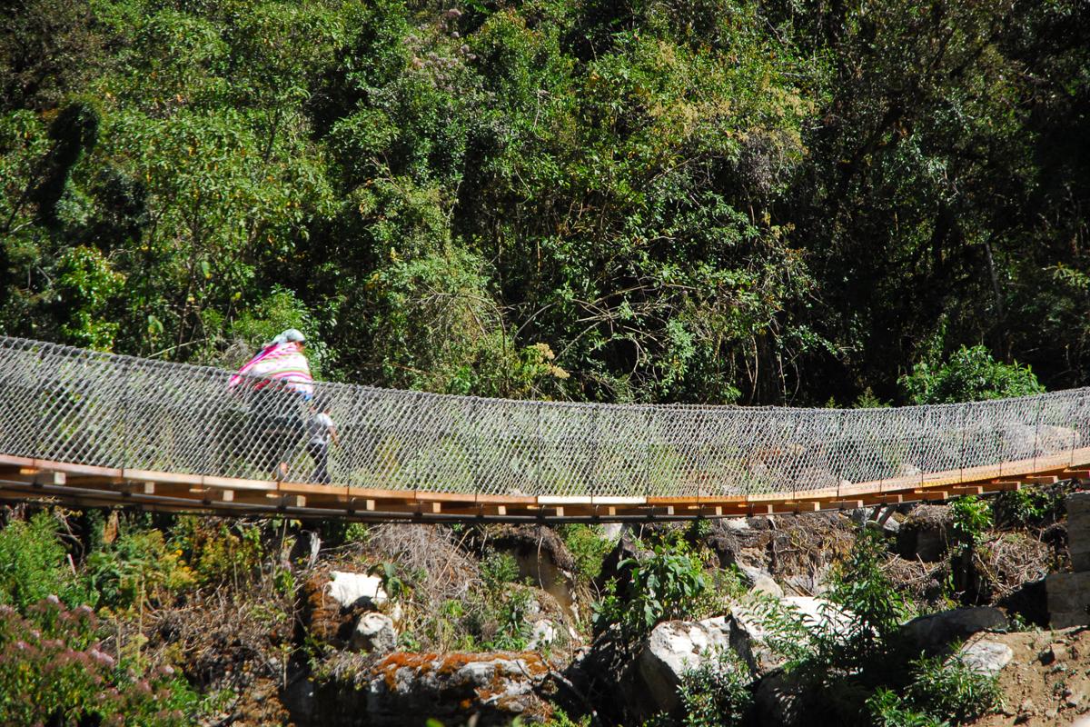 Old lady walking across bridge