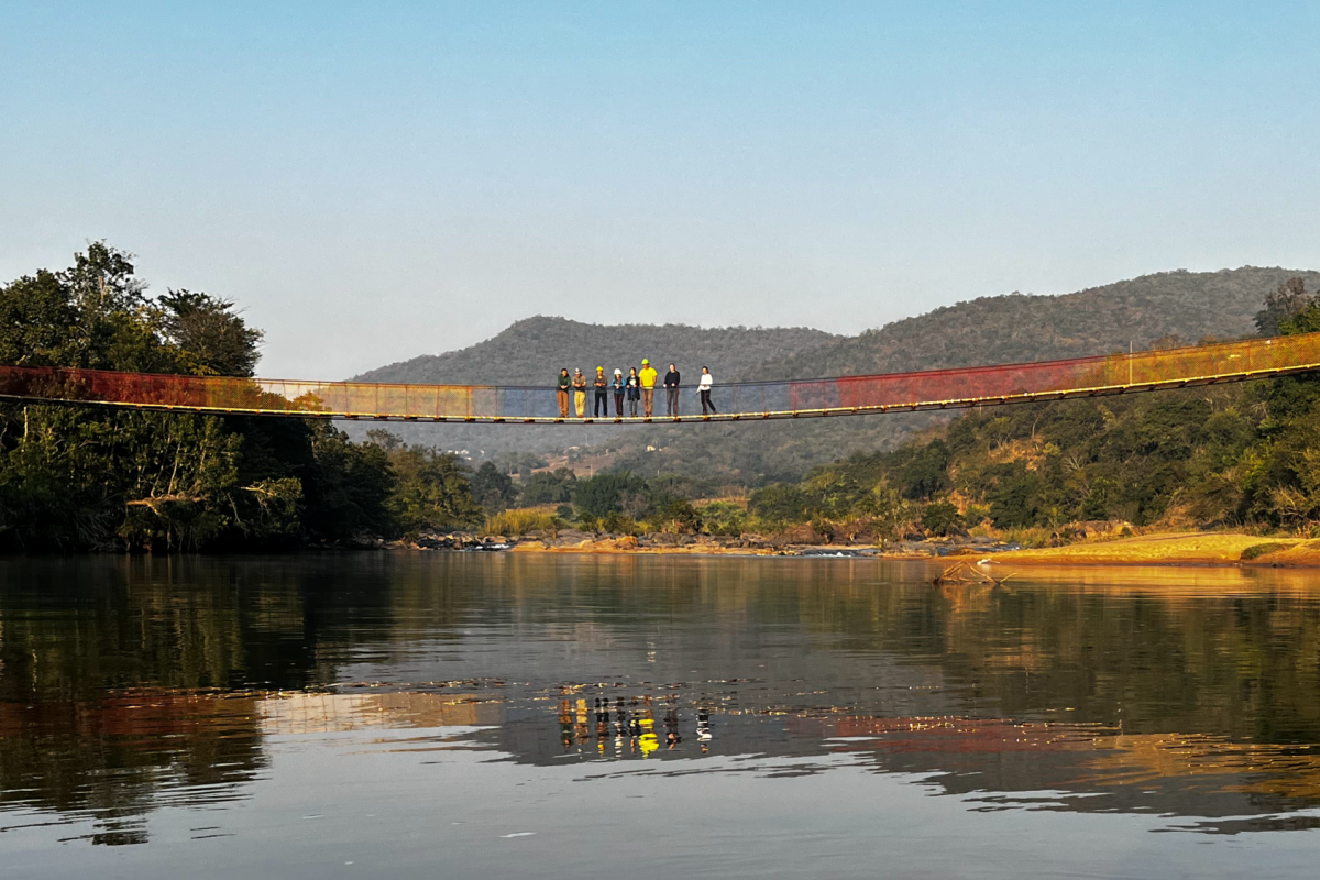 Side view of bridge with builders standing in middle