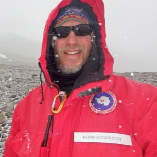 PolarTREC teacher Kevin Dickerson smiles in a snowstorm near McMurdo station, wearing his Big Red jacket for safety