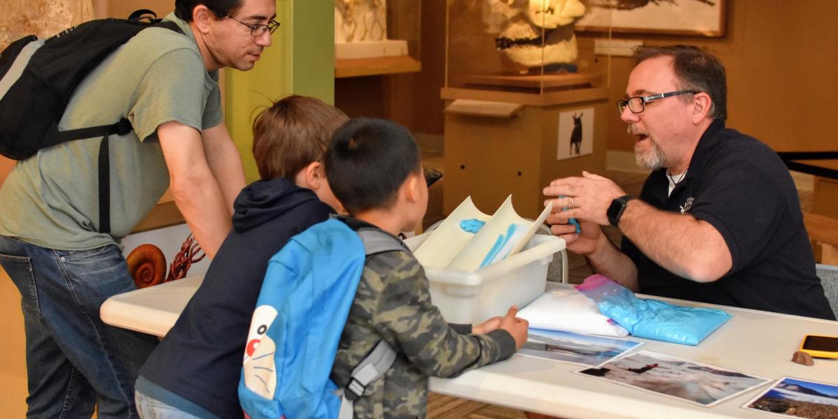 Mike Gooseff explaining glacial movement to a family