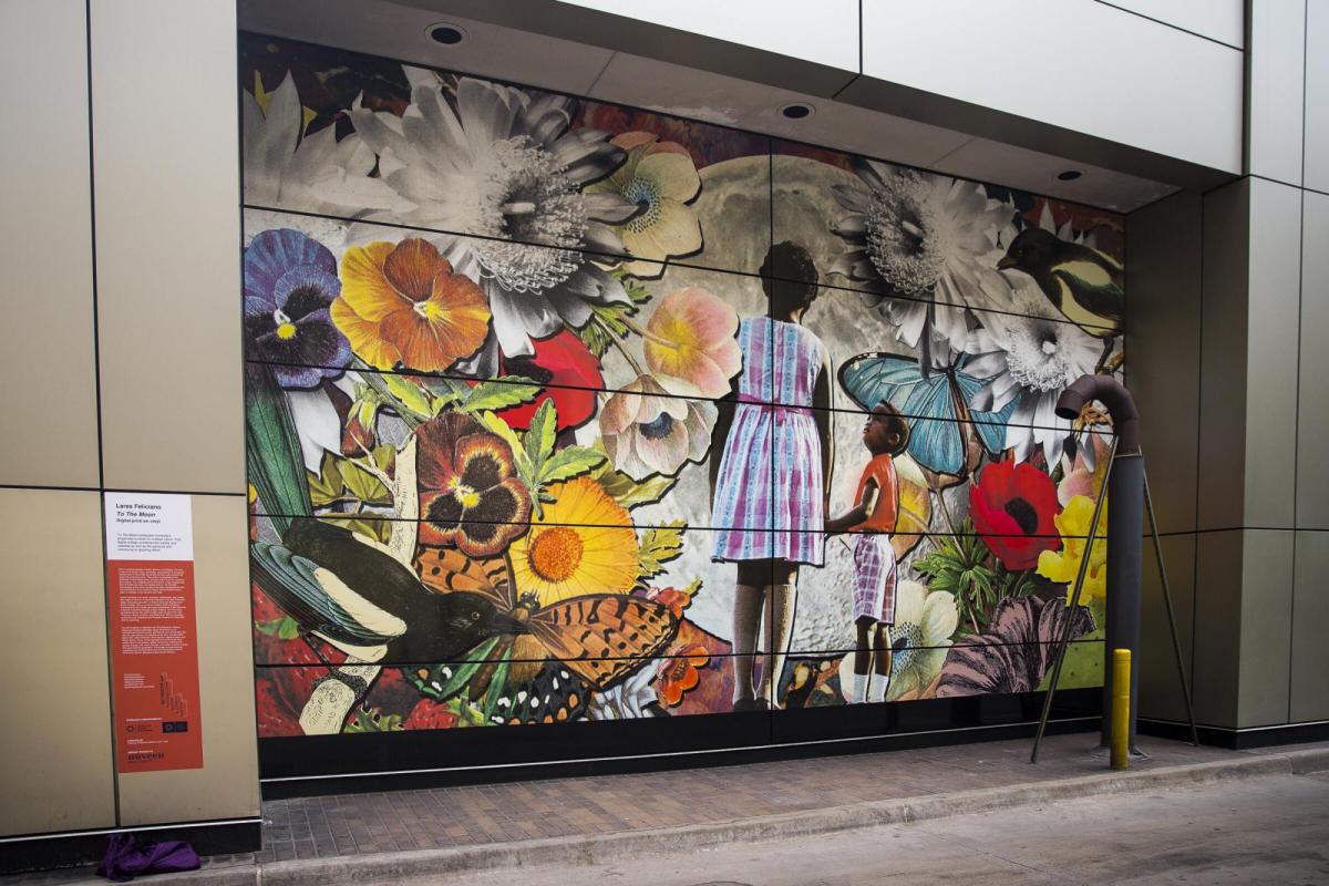 Mural by Lares Feliciano of young girl of color looking at flowers