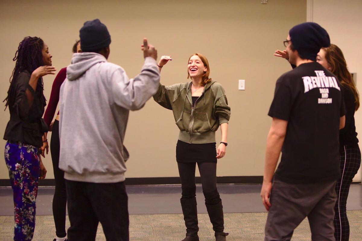Maya leads a theater group through an exercise