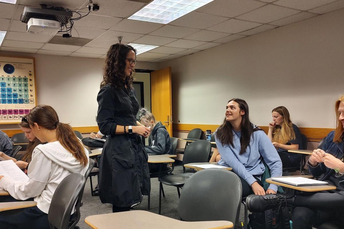 Rachael helps a student during class