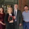 Ann Schmiesing, Joanne Guillery, Scott Battle, and David Meens gather to present Guillery with award.