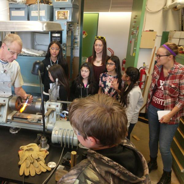 A researcher demonstrating his equipment to PISEC students and their UE