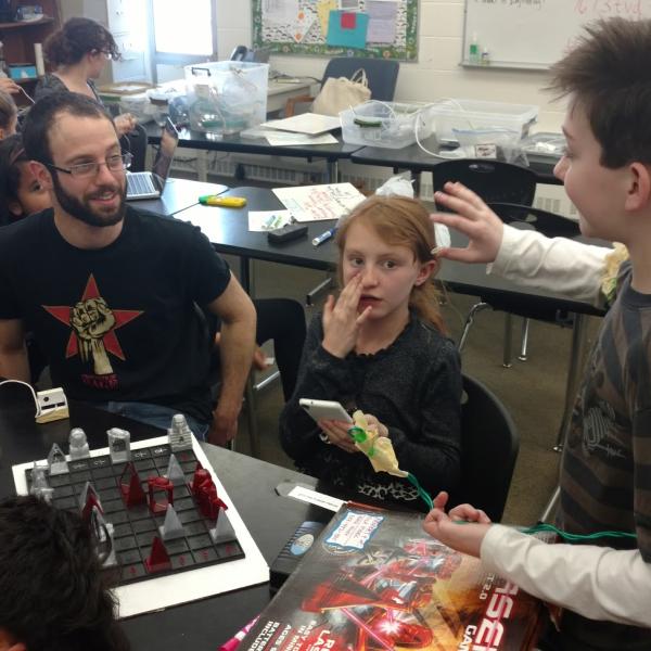 A PISEC UE playing laser chess with kids