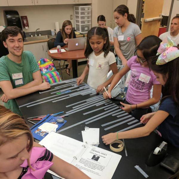 A PISEC UE and kids experimenting with scotch tape