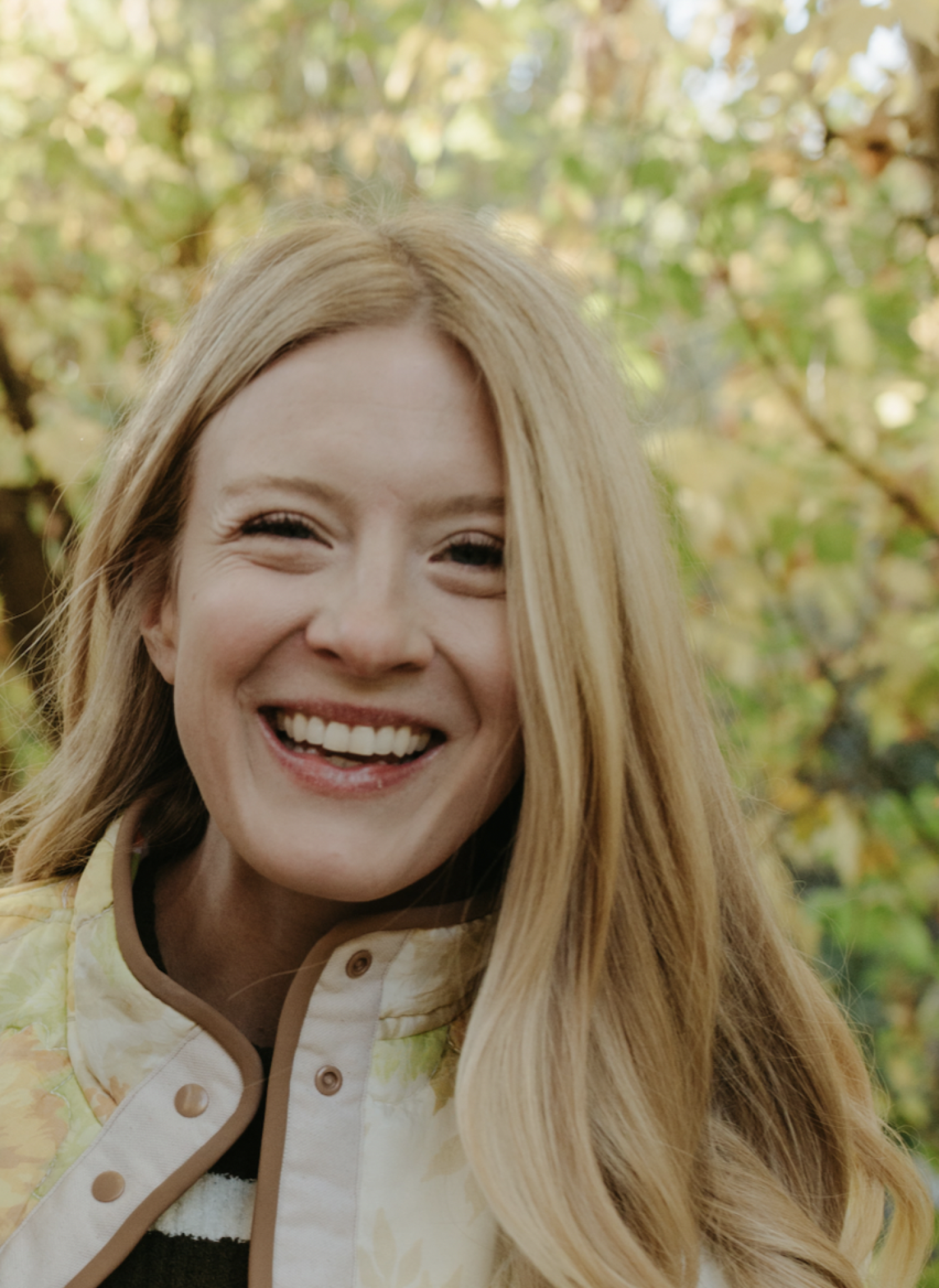 headshot of a smiling woman with long blonde hair