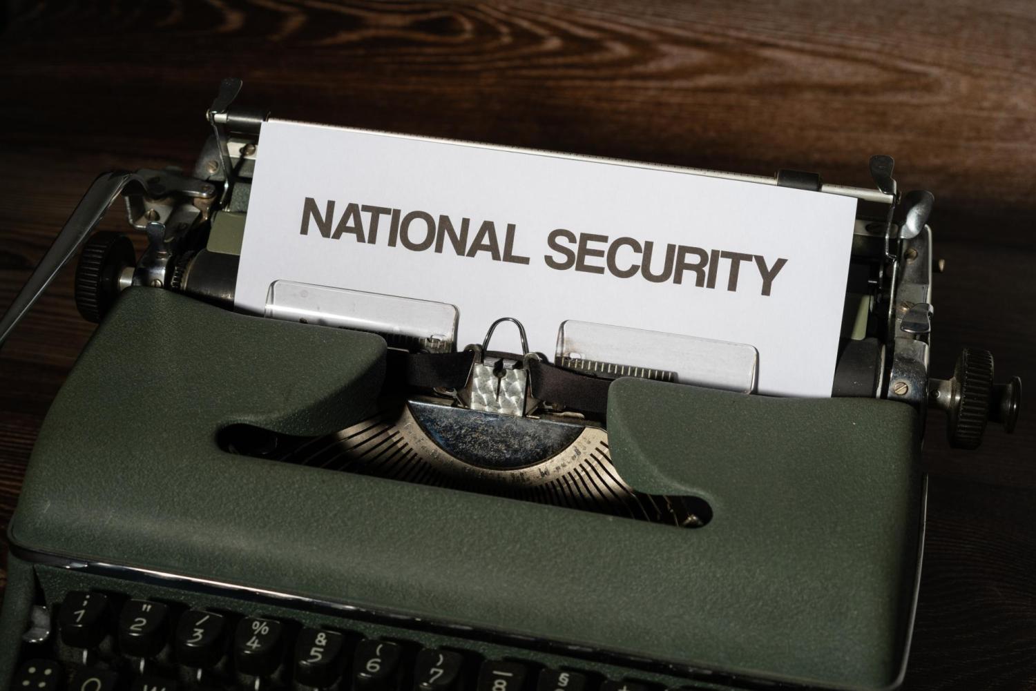 typewriter with words national security typed on white paper