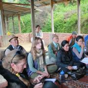 Alexandra sitting among others at an organic farming course