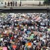 a-large-group-of-people-holding-up-signs on a street