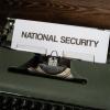 typewriter with words national security typed on white paper