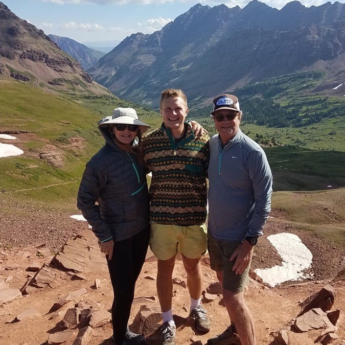 The Smith family standing in front of mountains